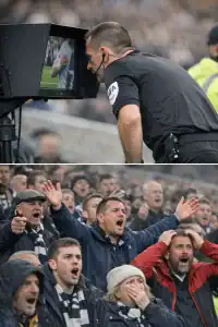 Referee reviewing handball decision during a football match.